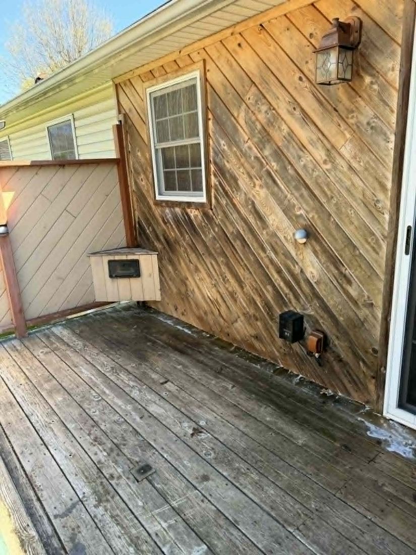 Gray weathered wood wall and deck before