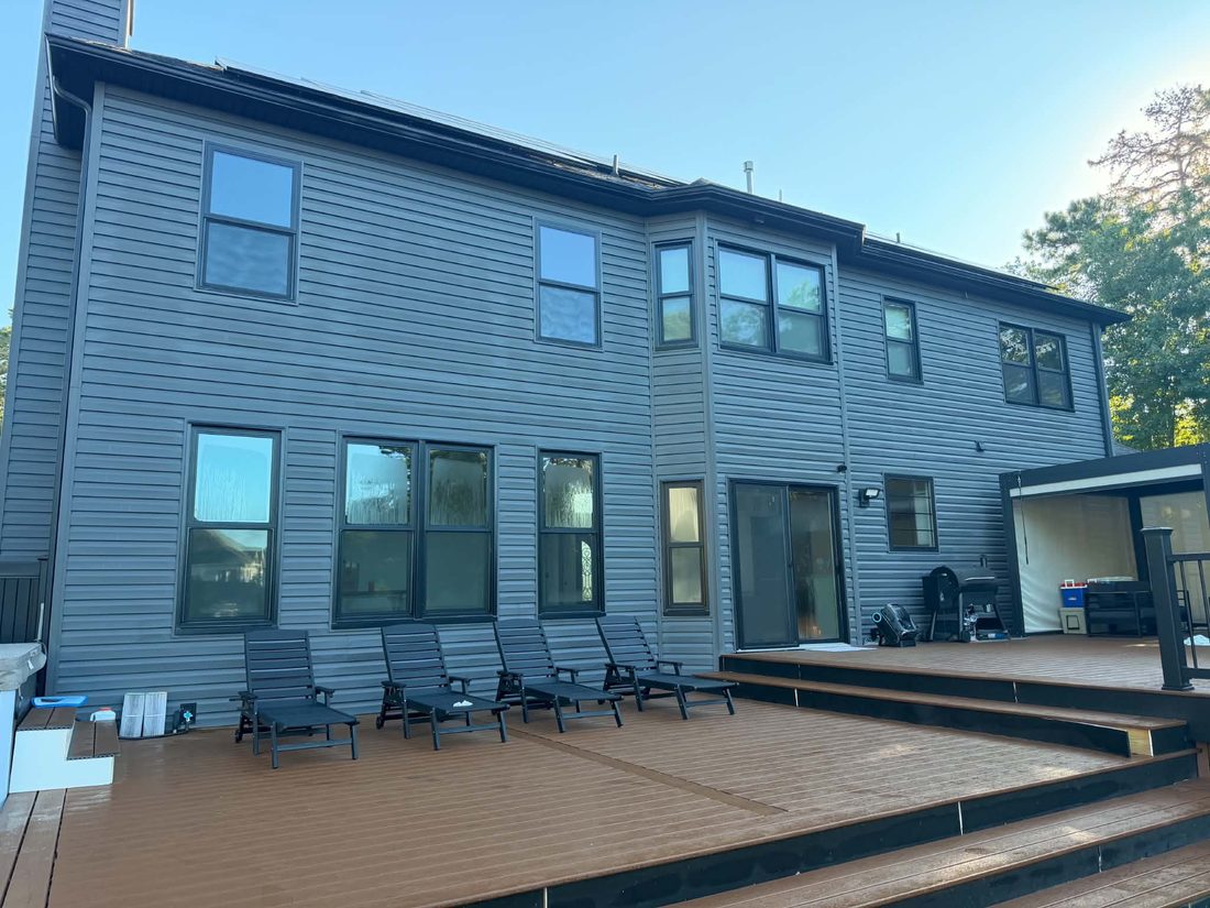 Full rear elevation with clean siding and finished deck