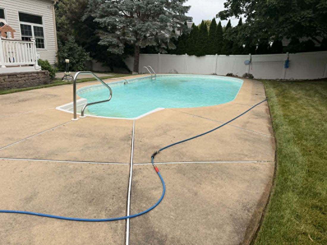 Stained pool deck before cleaning
